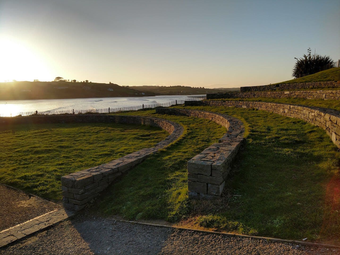 Outdoor stone seating overlooking the ocean.
